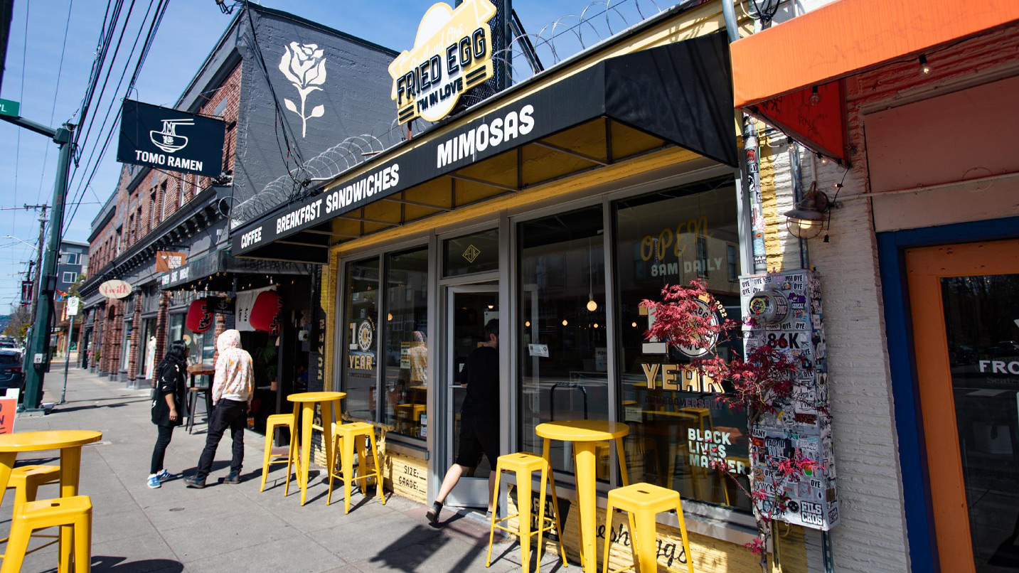 A street lined with small independent stores and restaurants.
