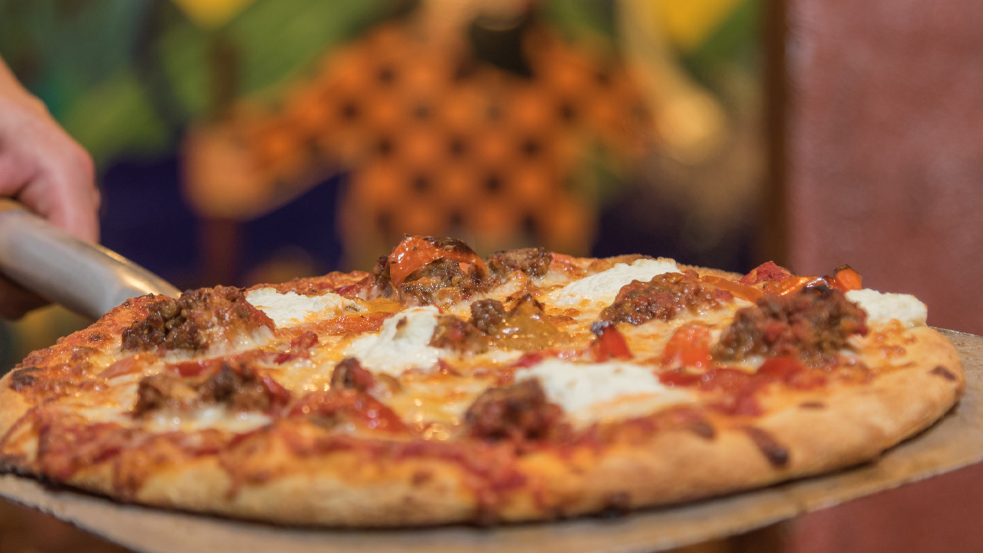 A person holding a pizza.