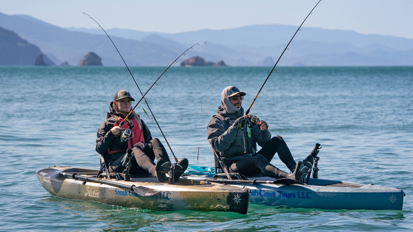 Two people fishing from sit-on-top kayaks.