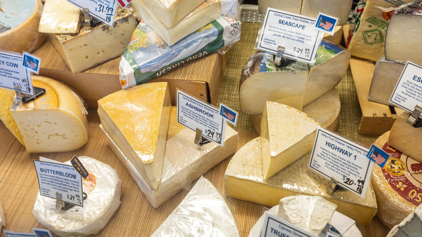 Cheese wedges on display for sale.