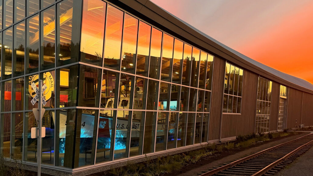 Sunset is reflected in the glass windows of a building.
