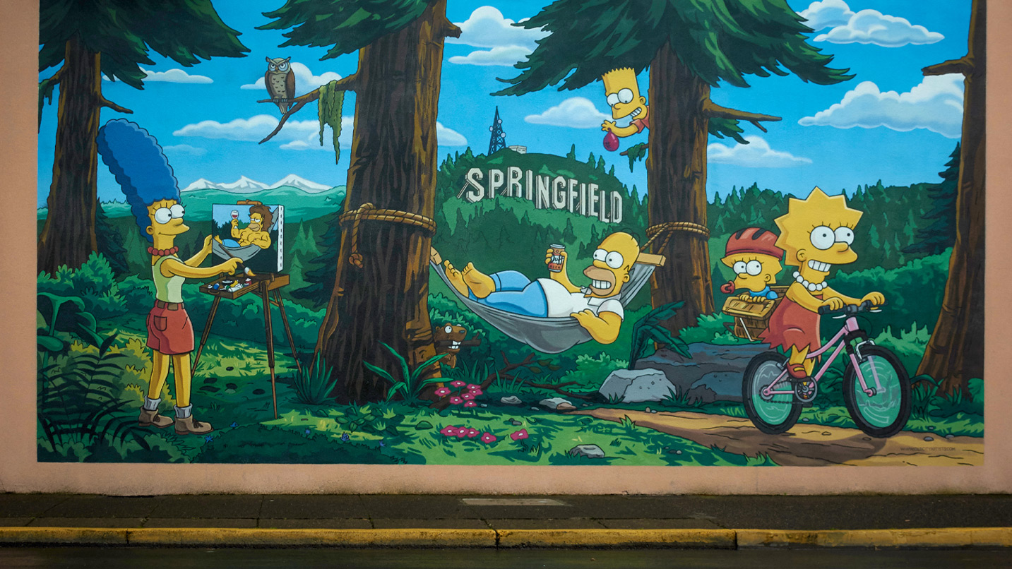 A mural of the animated family The Simpsons in nature. In the mural, there is a large sign atop an illustrated forested hill that reads "Springfield".